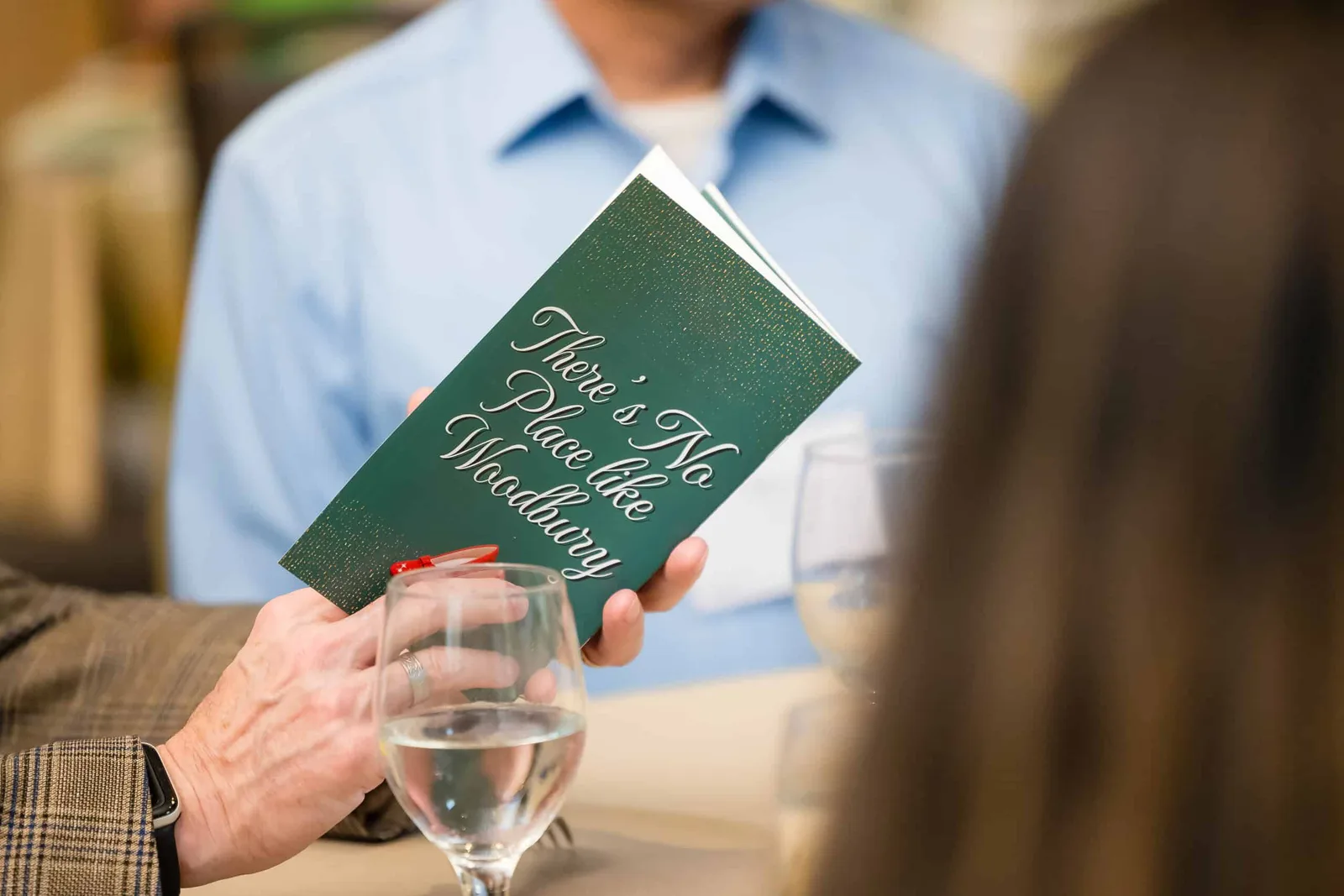 A guest with a Woodbury Community Foundation program at a foundation event