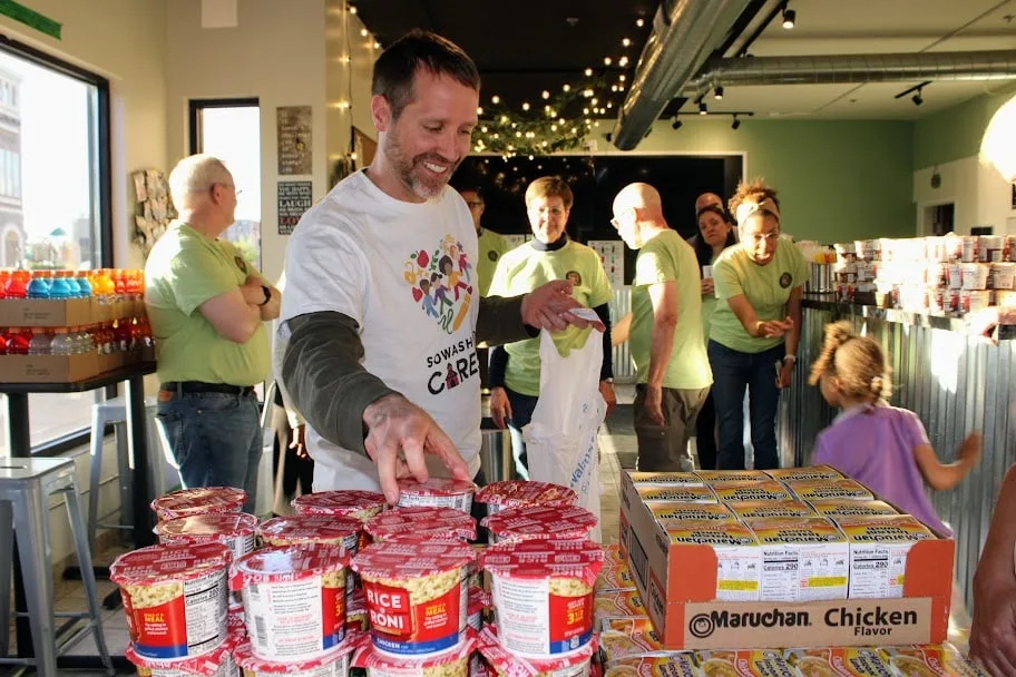 Volunteers sorting donated food at a community drive